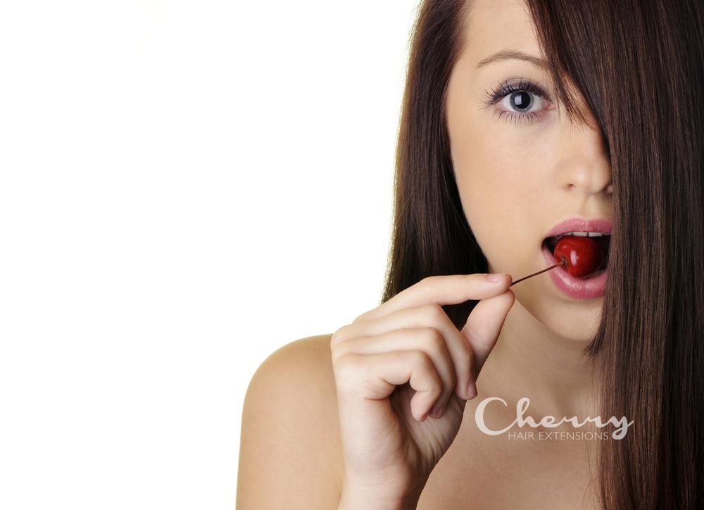Woman with a cherry in mouth